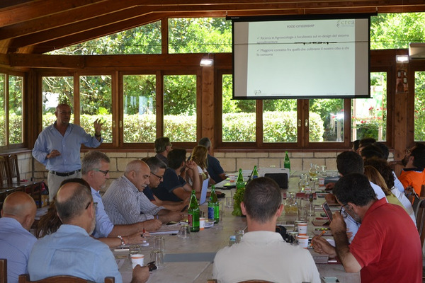 A group of people are listening to a presentation.